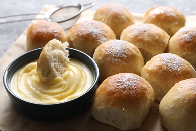 Delicious dough balls and sauce on grey table, closeup