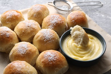 Photo of Delicious dough balls and sauce on grey table, closeup