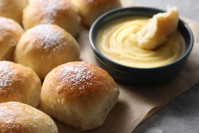 Delicious dough balls and sauce on grey table, closeup