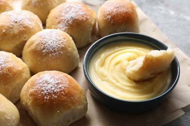 Delicious dough balls and sauce on grey table, closeup