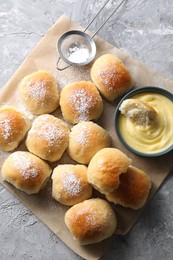 Delicious dough balls and sauce on grey table, top view