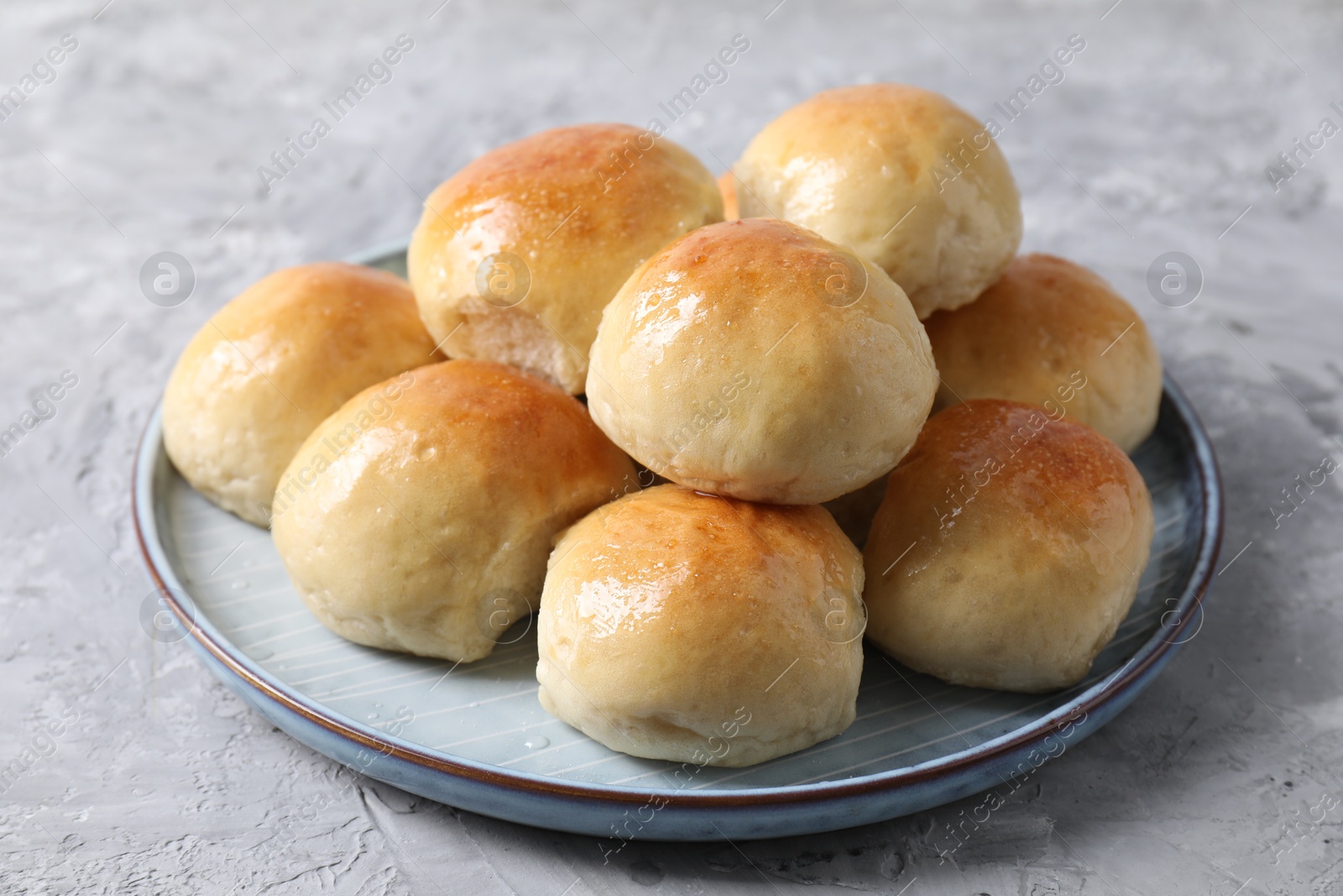 Photo of Delicious dough balls on grey table, closeup