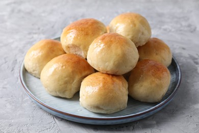 Delicious dough balls on grey table, closeup