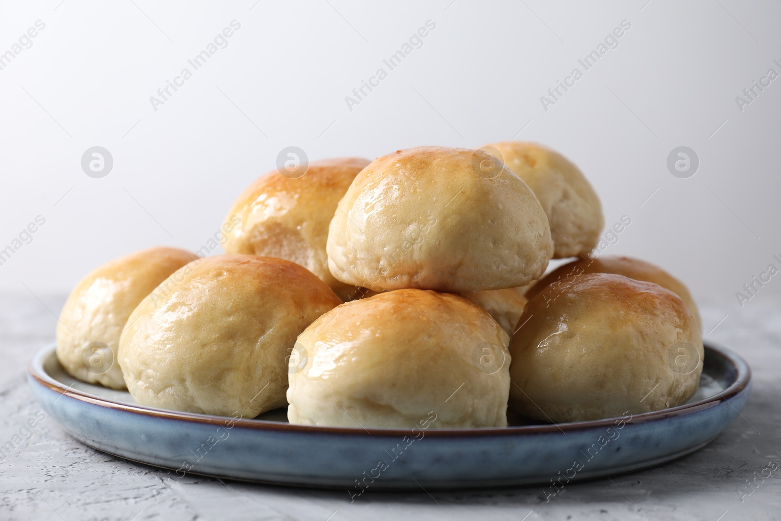 Photo of Delicious dough balls on grey table, closeup