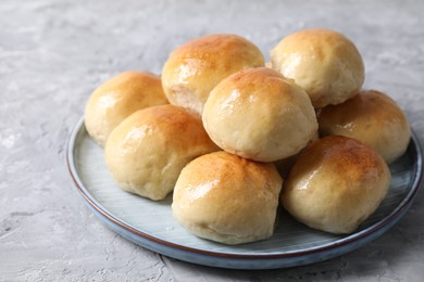 Delicious dough balls on grey table, closeup