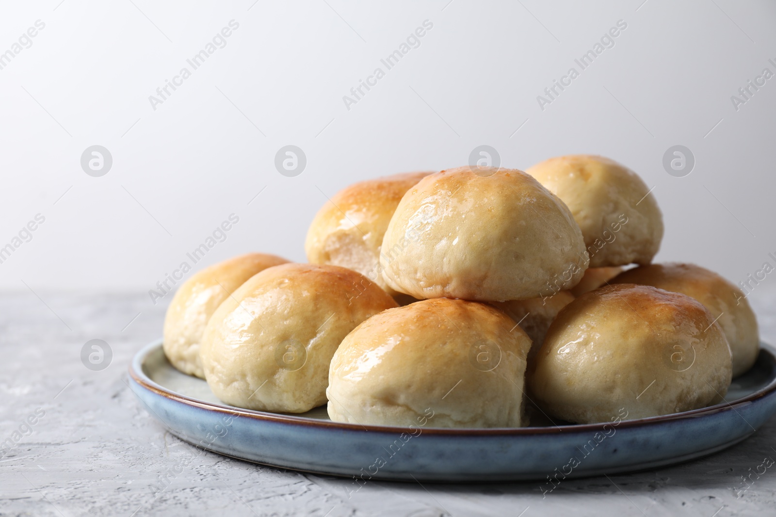 Photo of Delicious dough balls on grey table, closeup