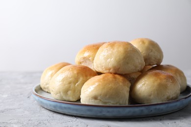 Delicious dough balls on grey table, closeup