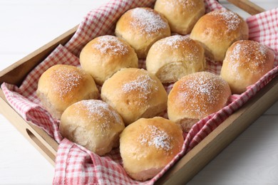 Photo of Delicious dough balls in crate on white table