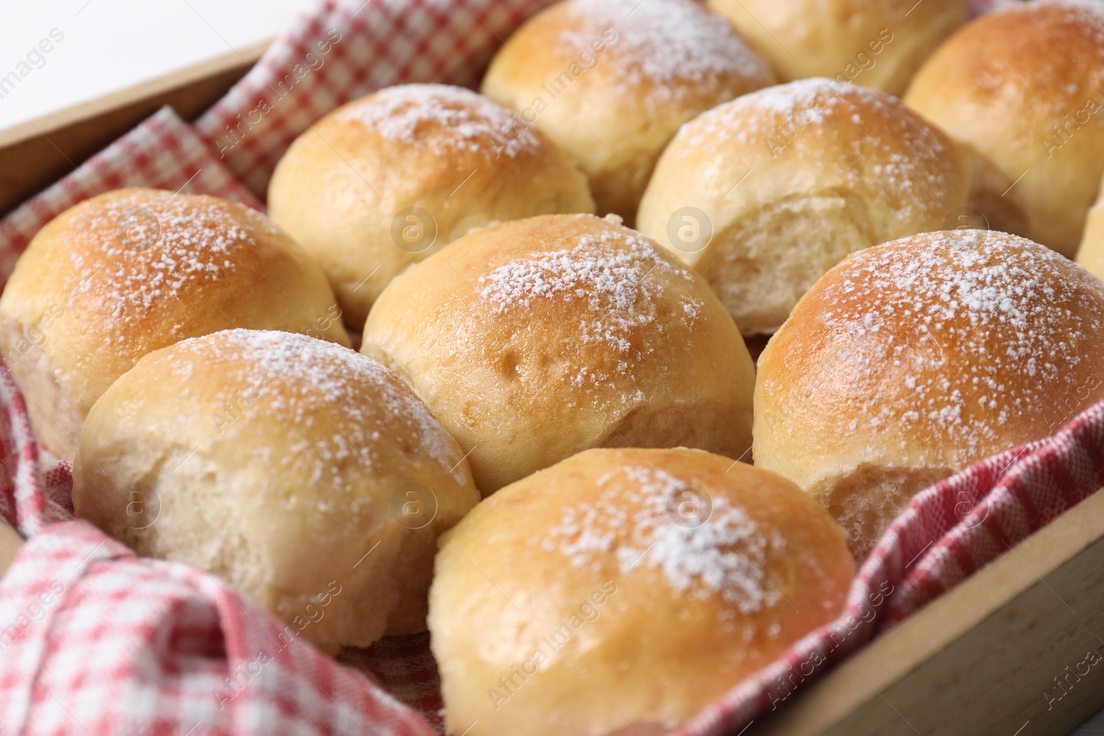 Photo of Delicious dough balls in wooden crate, closeup