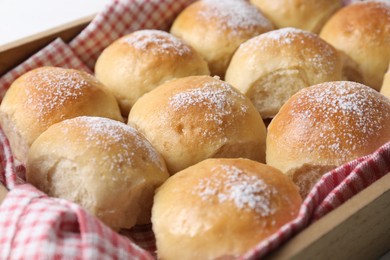 Photo of Delicious dough balls in wooden crate, closeup