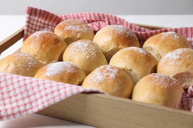 Delicious dough balls in crate on table, closeup