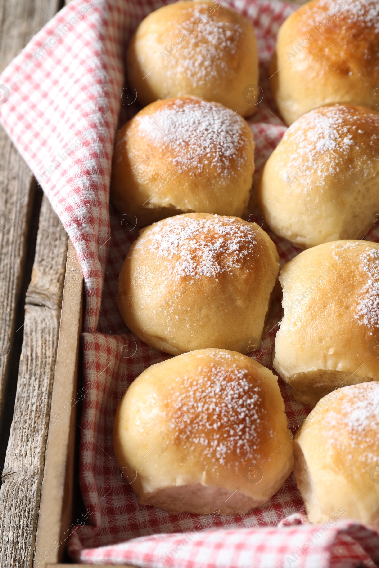 Photo of Delicious dough balls on wooden table, closeup