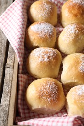 Photo of Delicious dough balls on wooden table, closeup