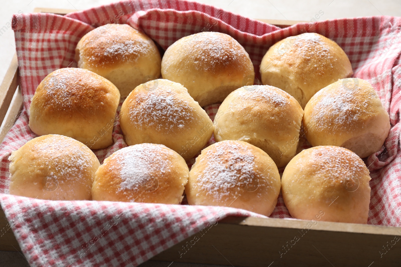 Photo of Delicious dough balls in wooden crate, closeup