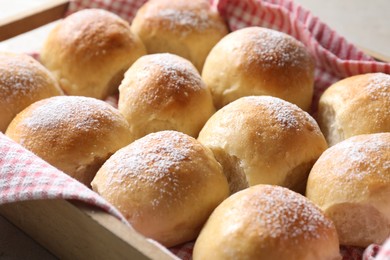 Photo of Delicious dough balls in wooden crate, closeup