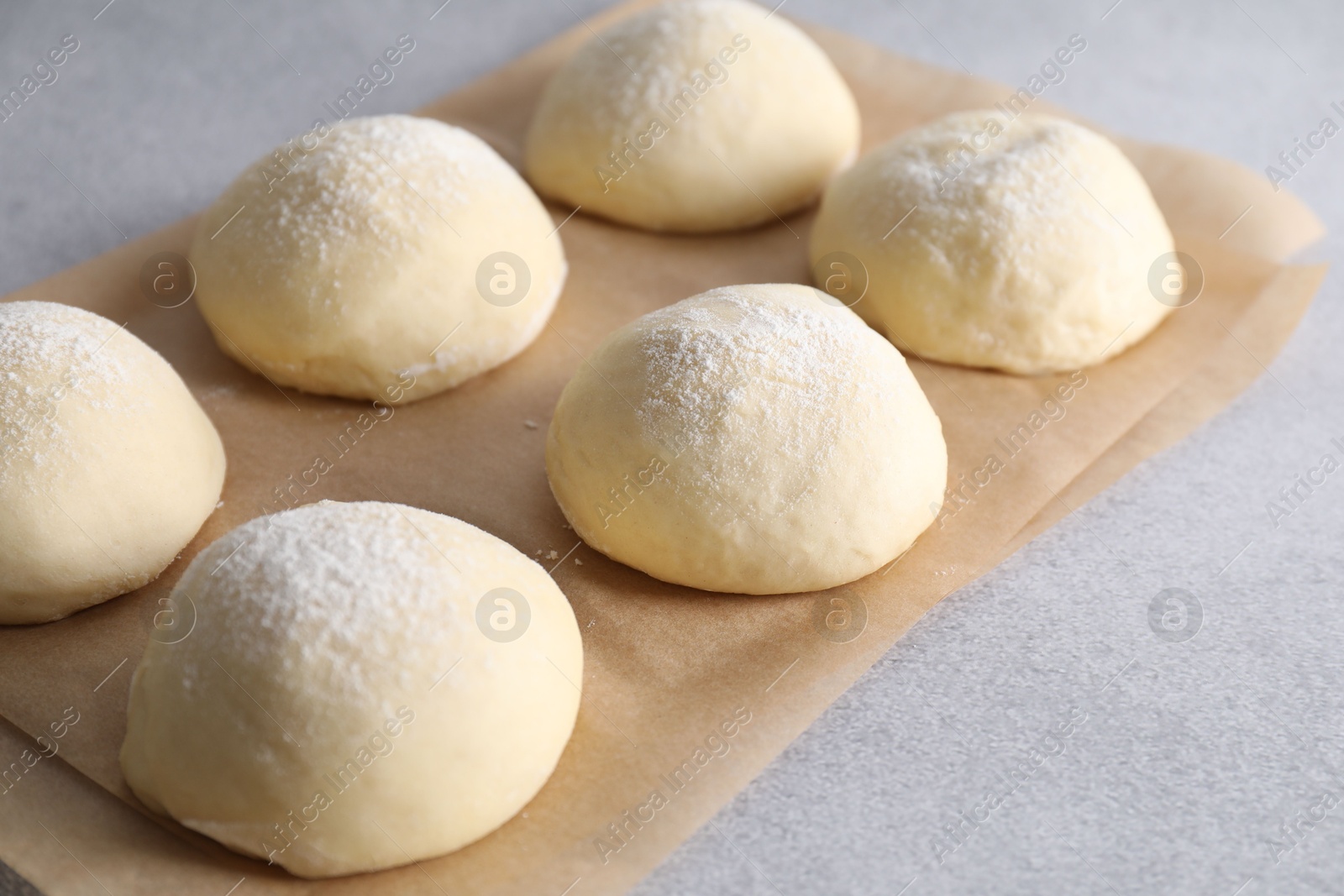 Photo of Raw dough balls on light grey table