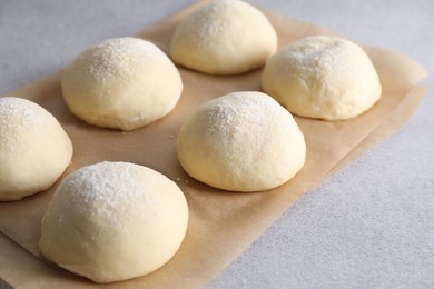 Raw dough balls on light grey table