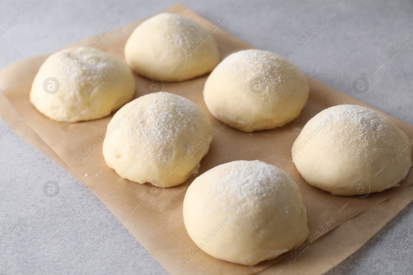 Photo of Raw dough balls on light grey table