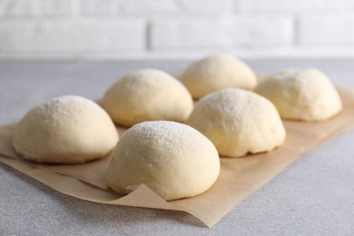 Raw dough balls on light grey table