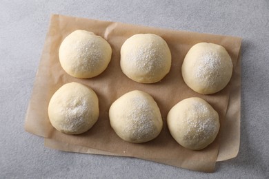 Raw dough balls on light grey table, top view