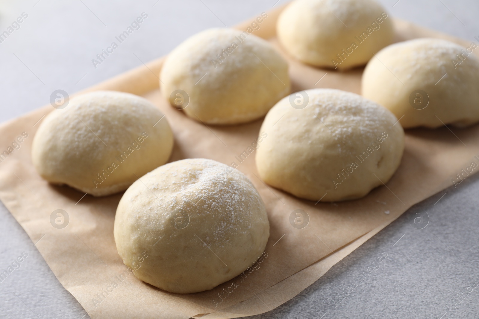 Photo of Raw dough balls on light grey table