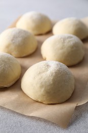 Raw dough balls on light grey table