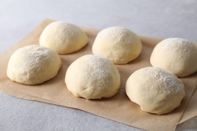 Raw dough balls on light grey table