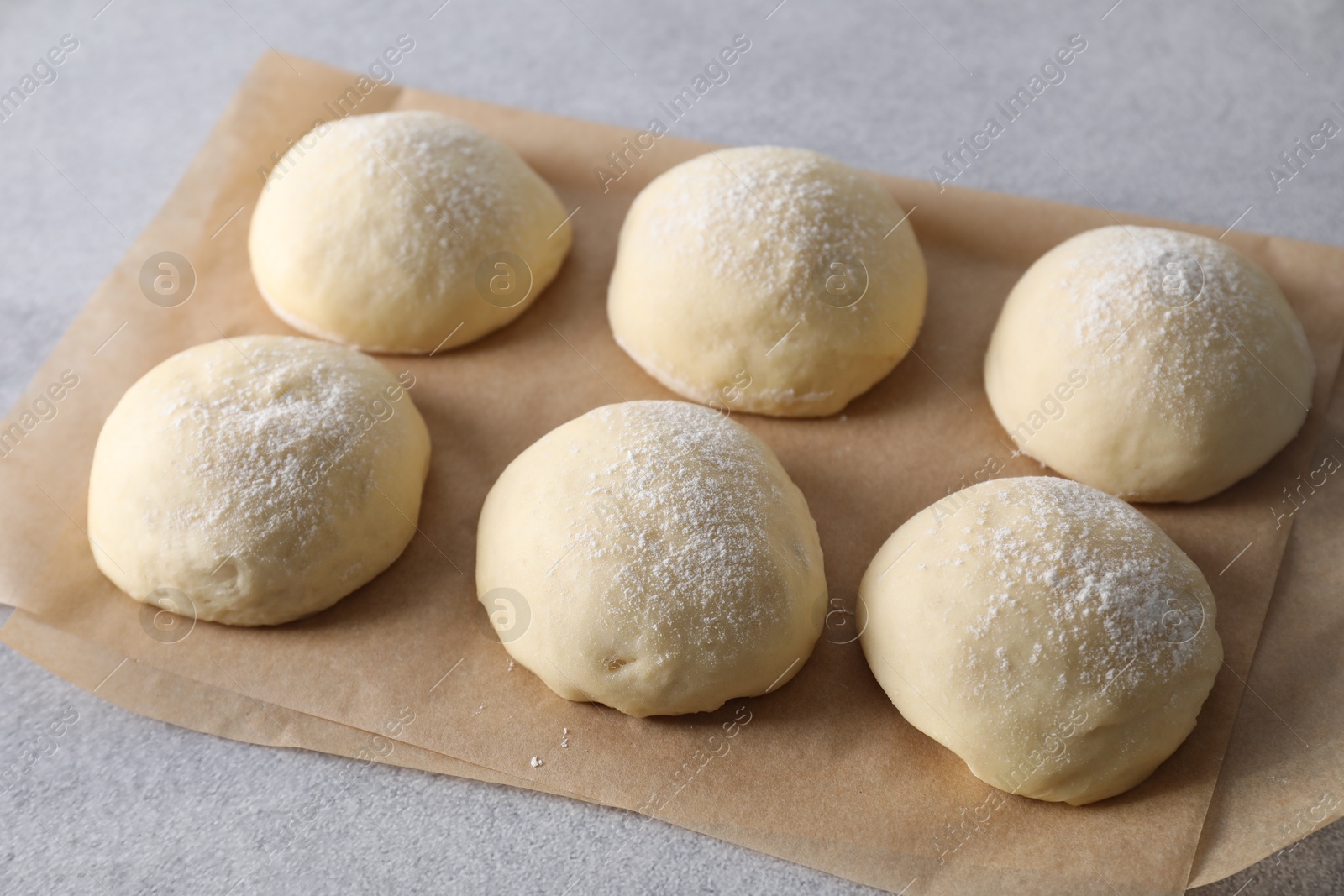 Photo of Raw dough balls on light grey table