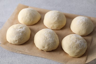 Raw dough balls on light grey table