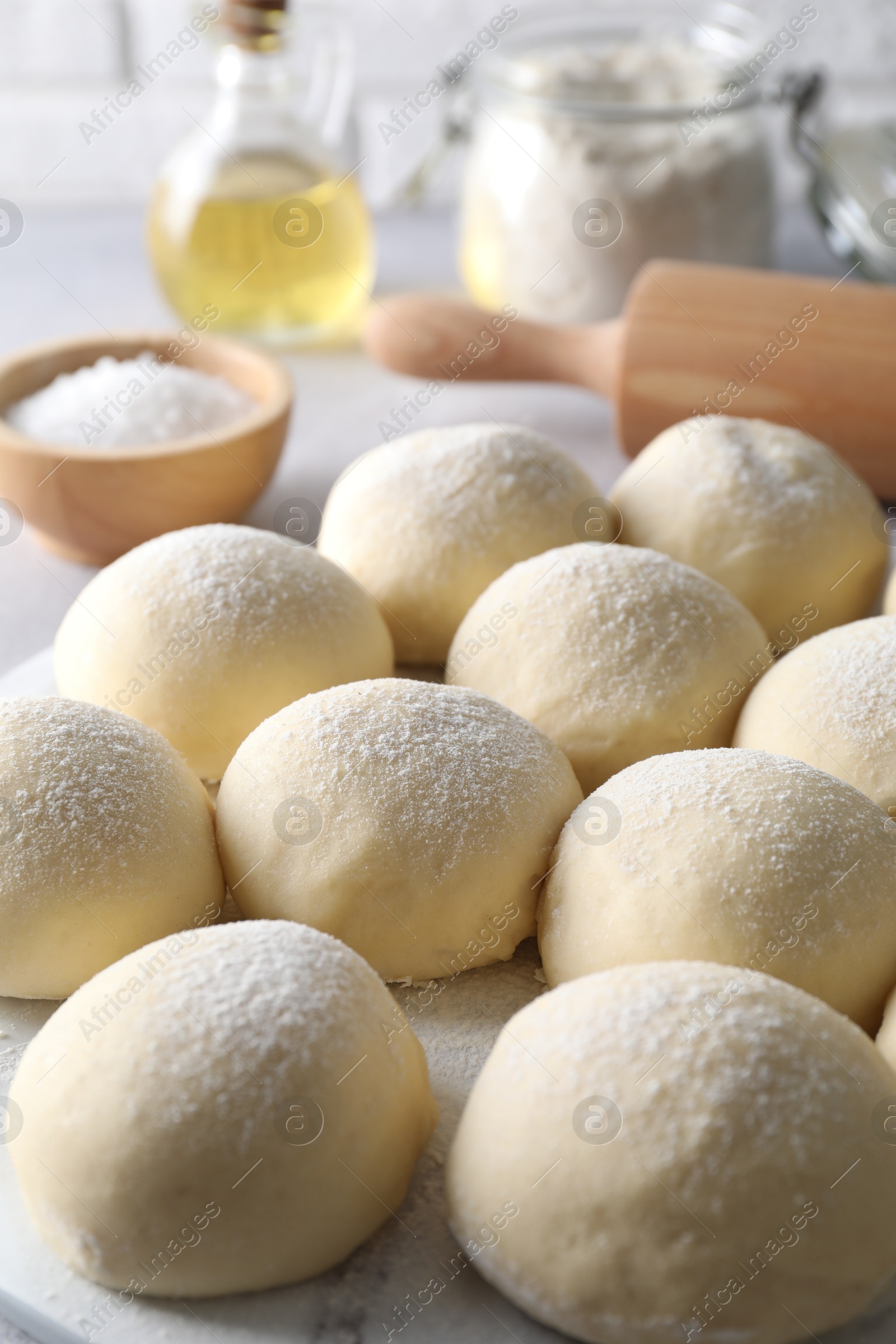 Photo of Many raw dough balls on table, closeup