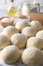 Many raw dough balls on table, closeup