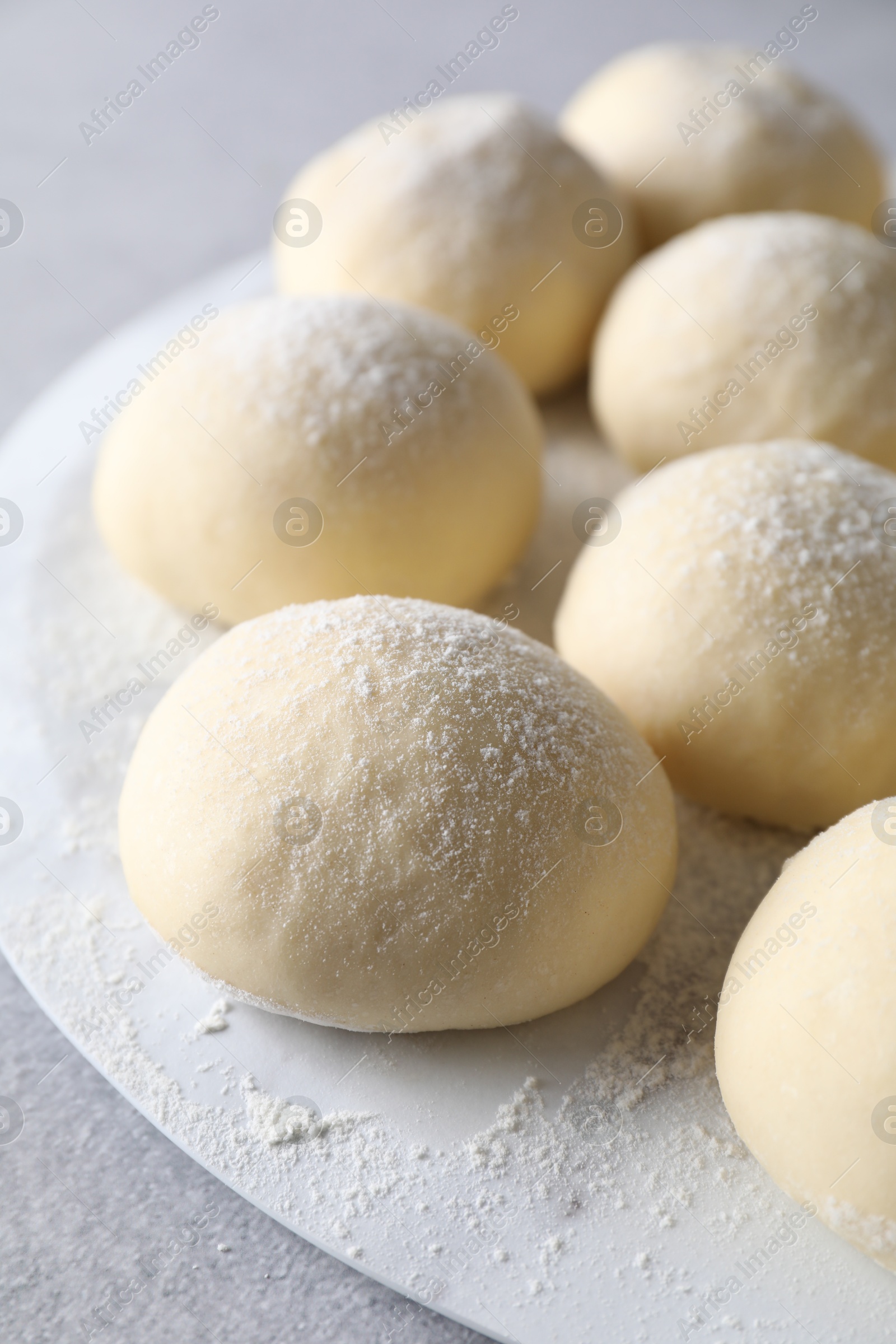 Photo of Raw dough balls on light grey table