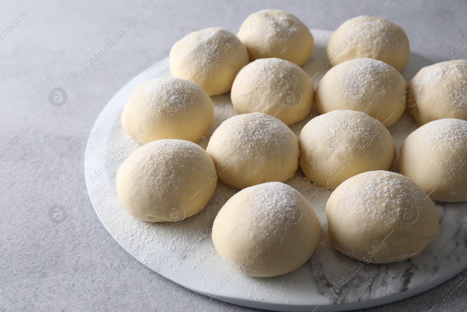 Photo of Raw dough balls on light grey table