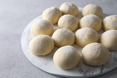 Raw dough balls on light grey table