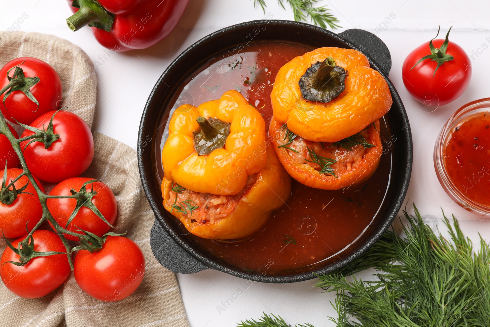 Photo of Tasty stuffed peppers and products on light table, flat lay