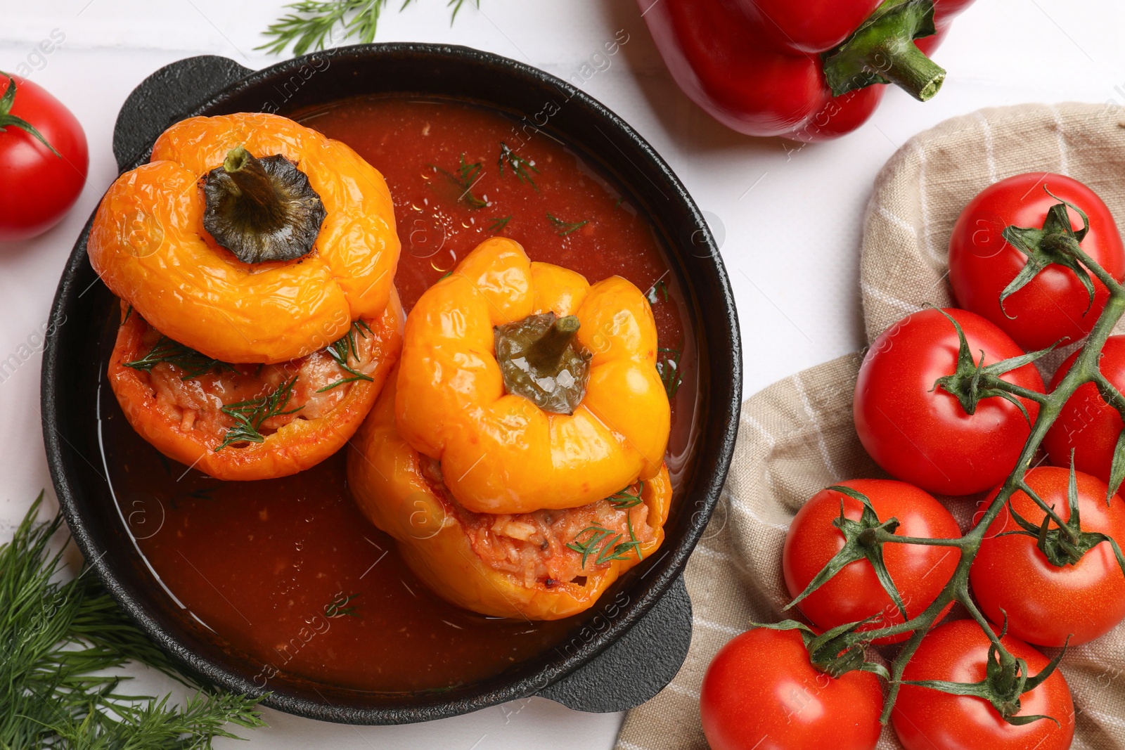 Photo of Tasty stuffed peppers and products on light table, flat lay