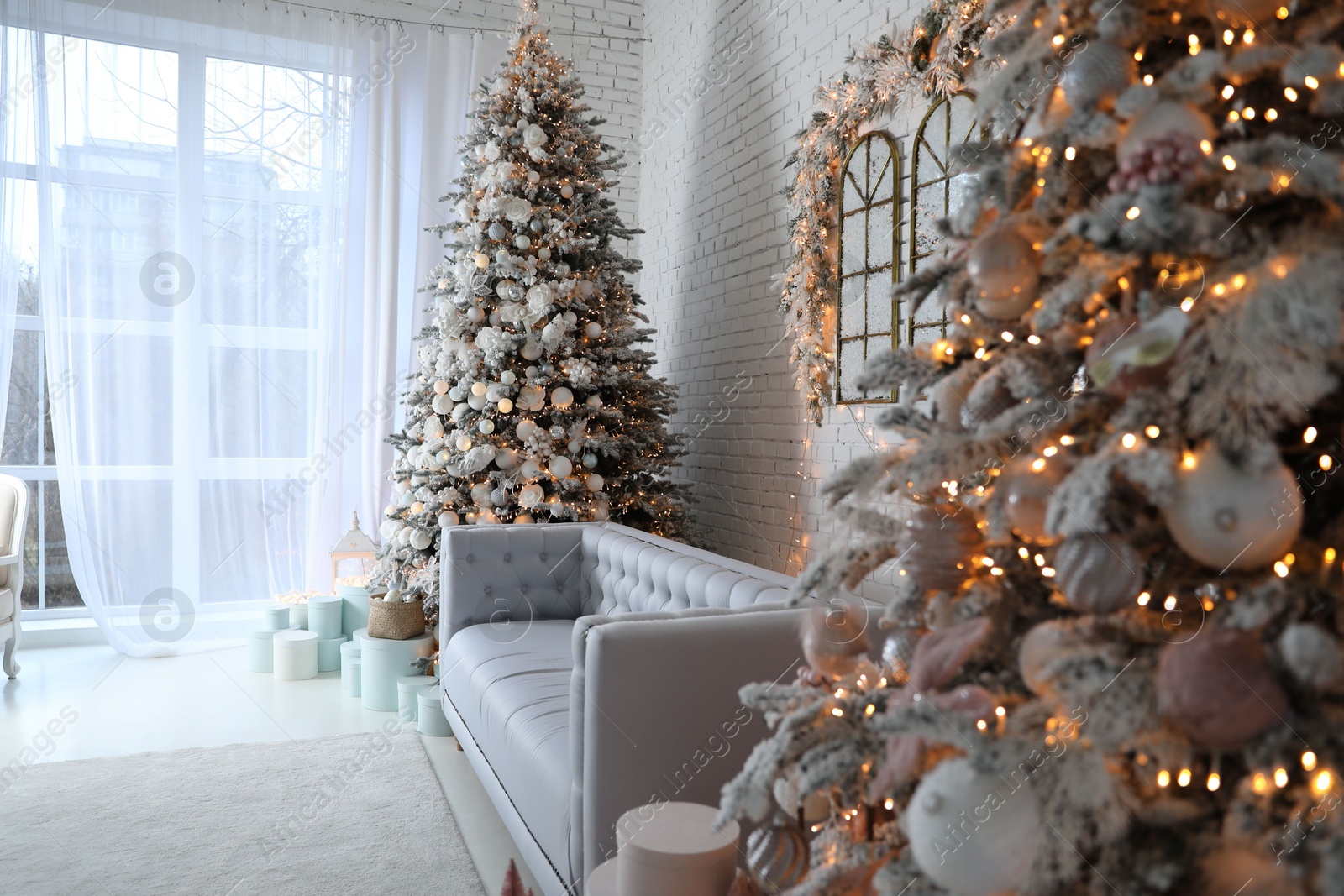 Photo of Beautiful interior of living room with decorated Christmas trees