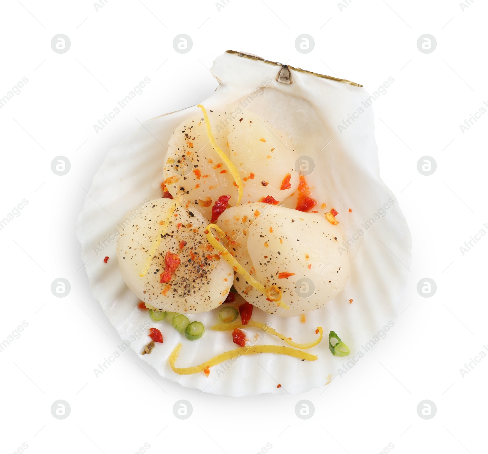 Photo of Raw scallop with lemon zest, green onion, spices and shell isolated on white, top view