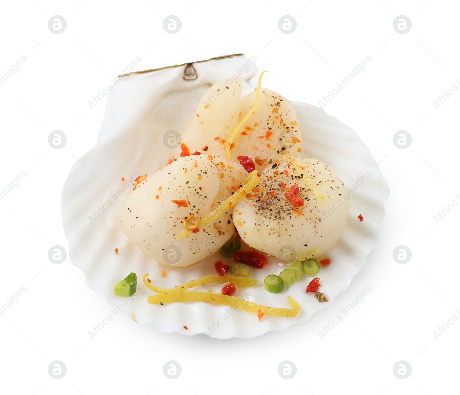 Photo of Raw scallop with lemon zest, green onion, spices and shell isolated on white