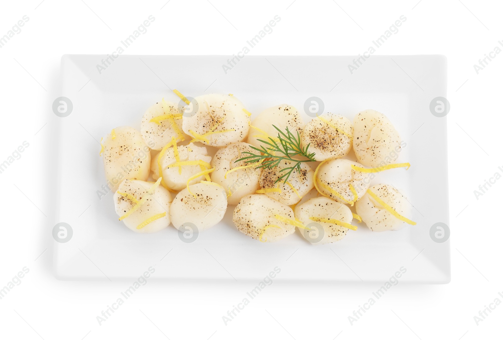 Photo of Raw scallops with milled pepper, dill and lemon zest isolated on white, top view
