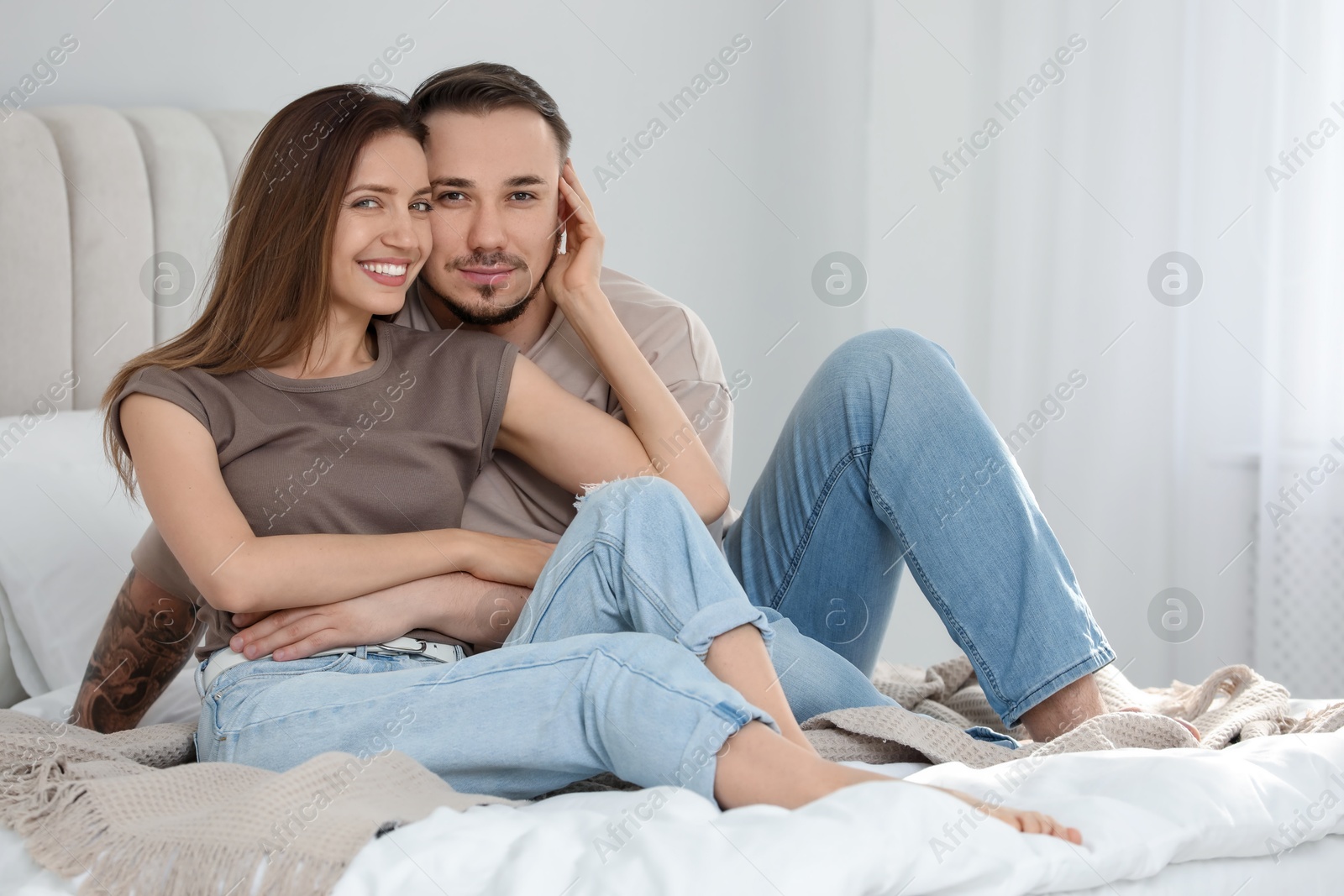 Photo of Family portrait of lovely couple on bed at home