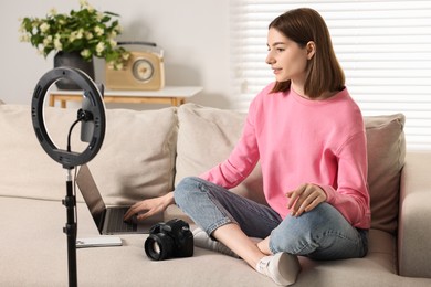 Photo of Technology blogger recording video with smartphone and ring lamp at home