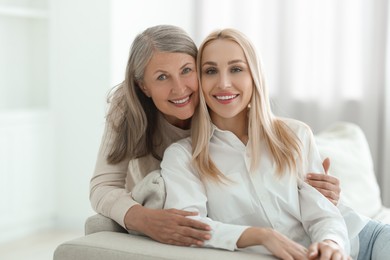 Family portrait of young woman and her mother at home