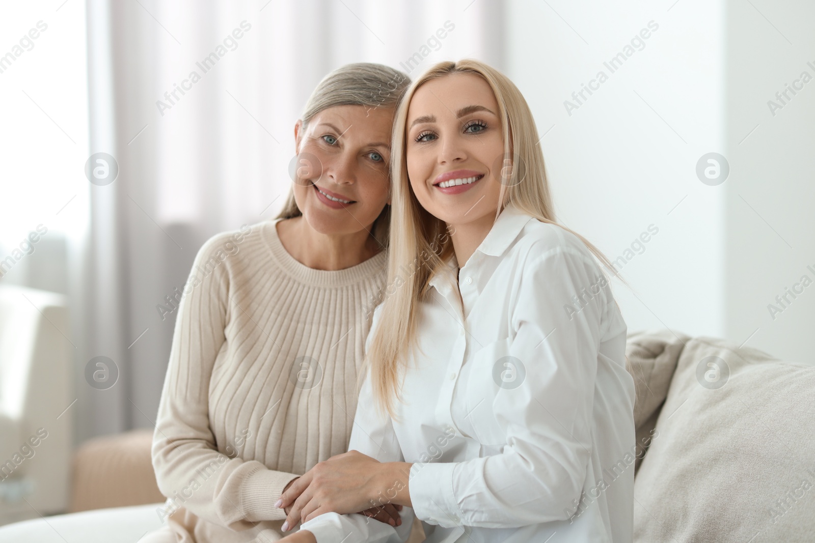 Photo of Family portrait of young woman and her mother at home