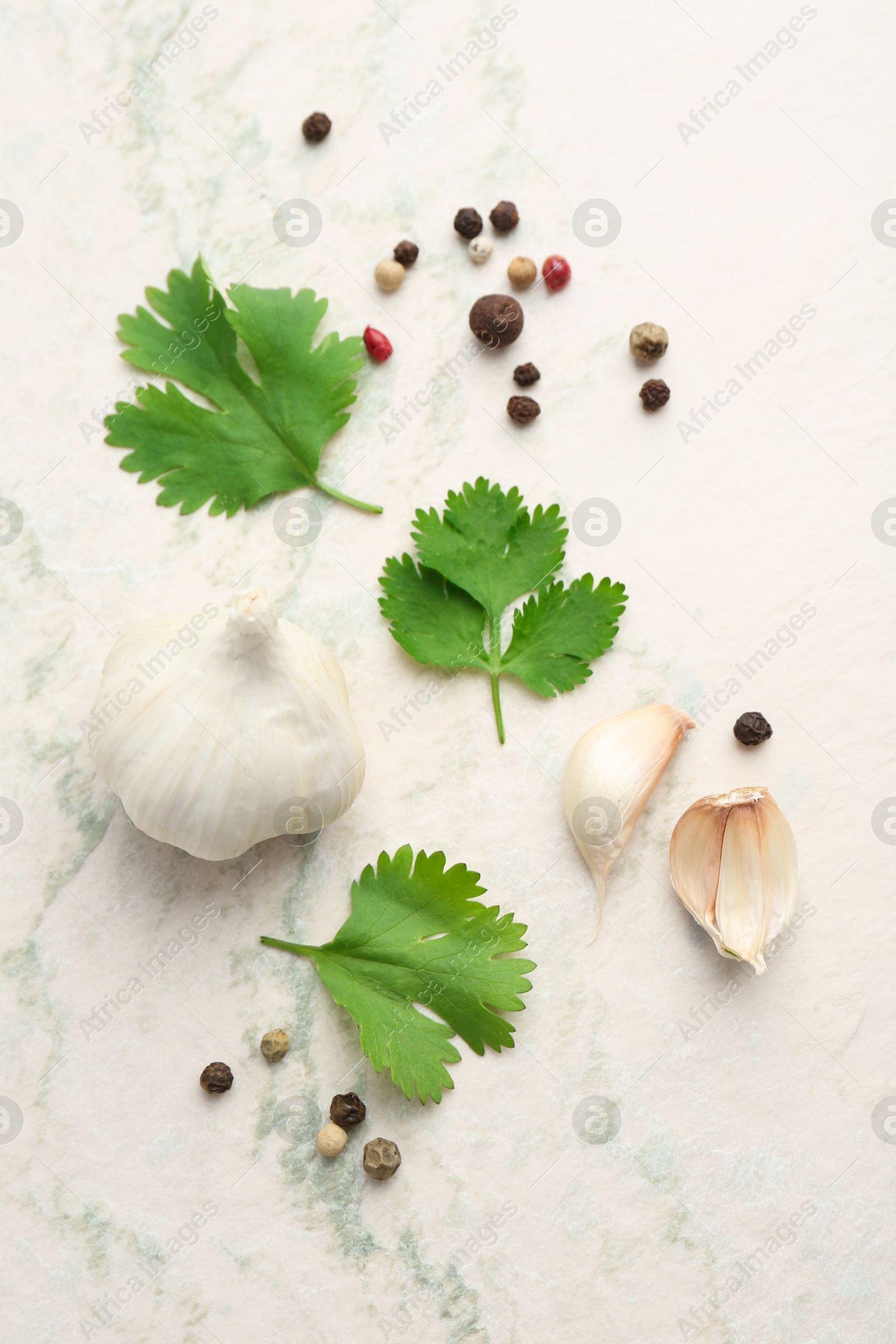 Photo of Fresh coriander leaves, garlic and peppercorns on light textured table, flat lay