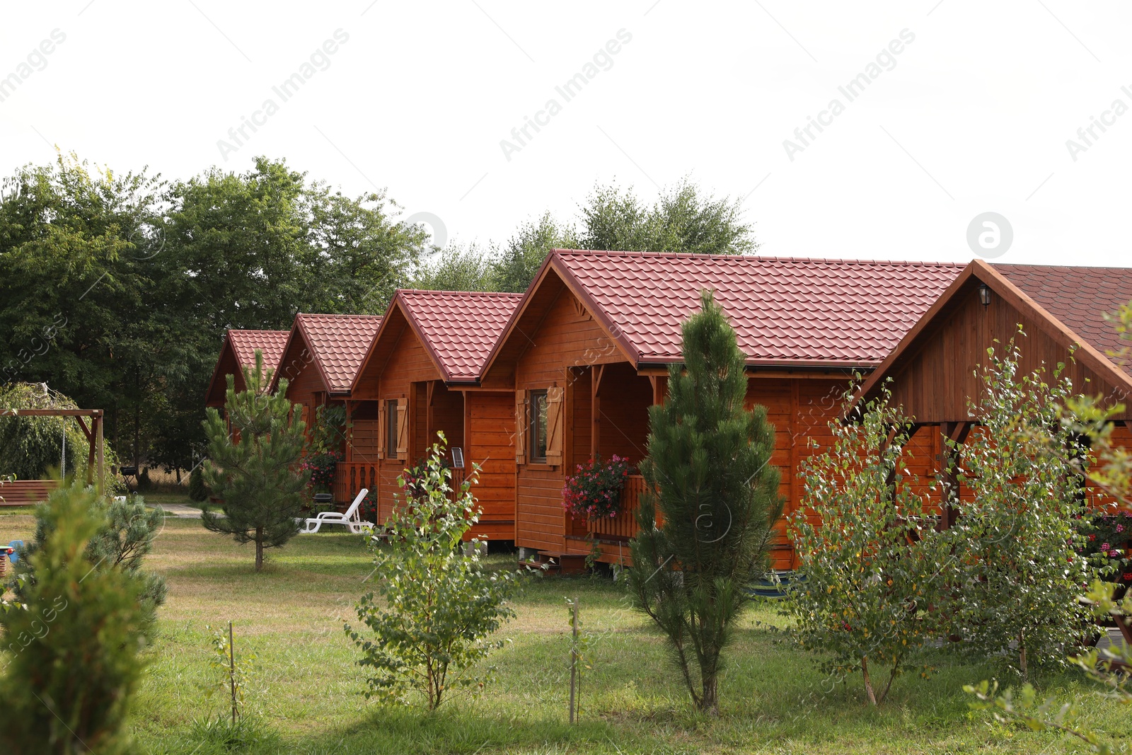 Photo of Beautiful wooden beach houses and green trees outdoors