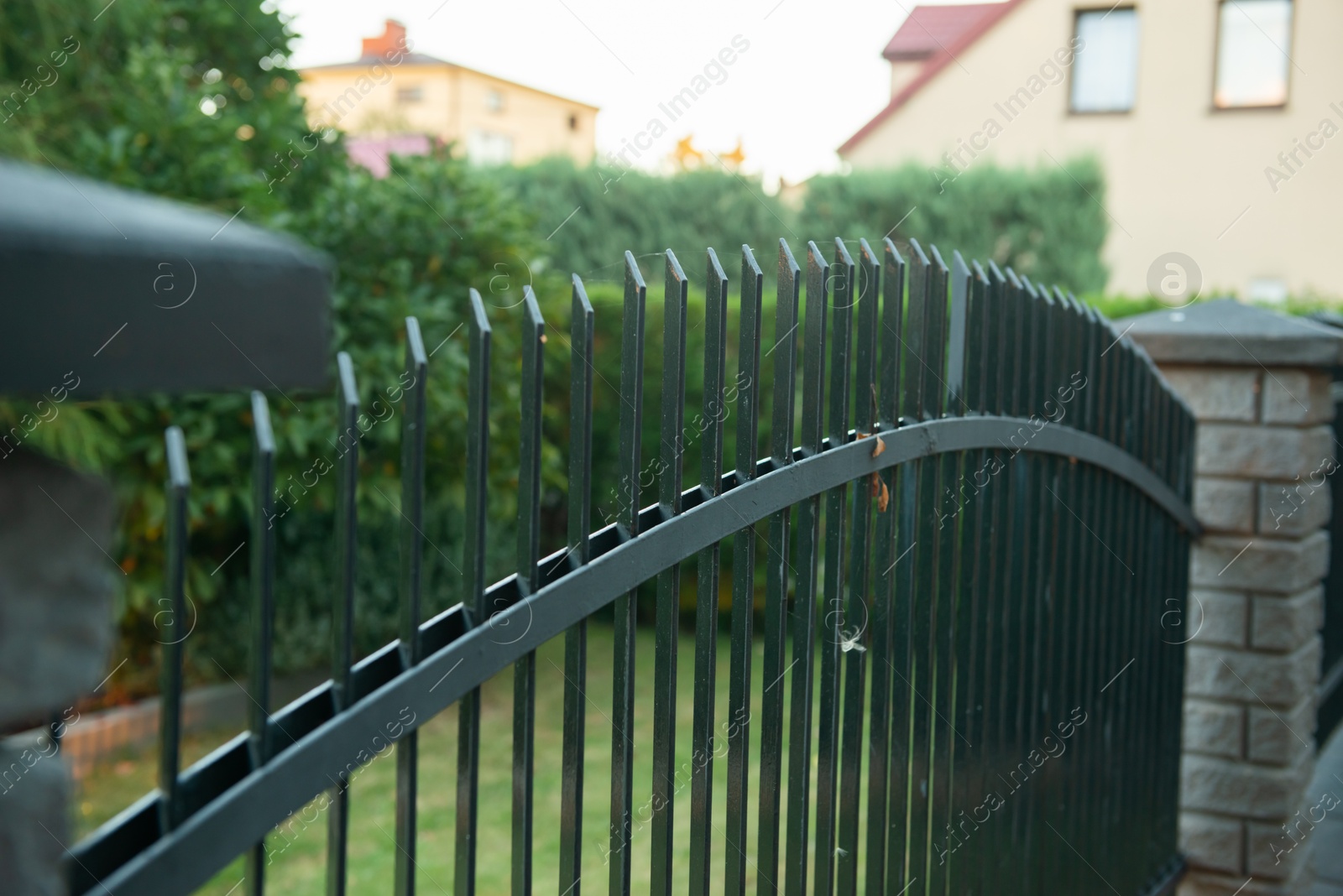 Photo of Iron railing of beautiful fence outdoors, closeup