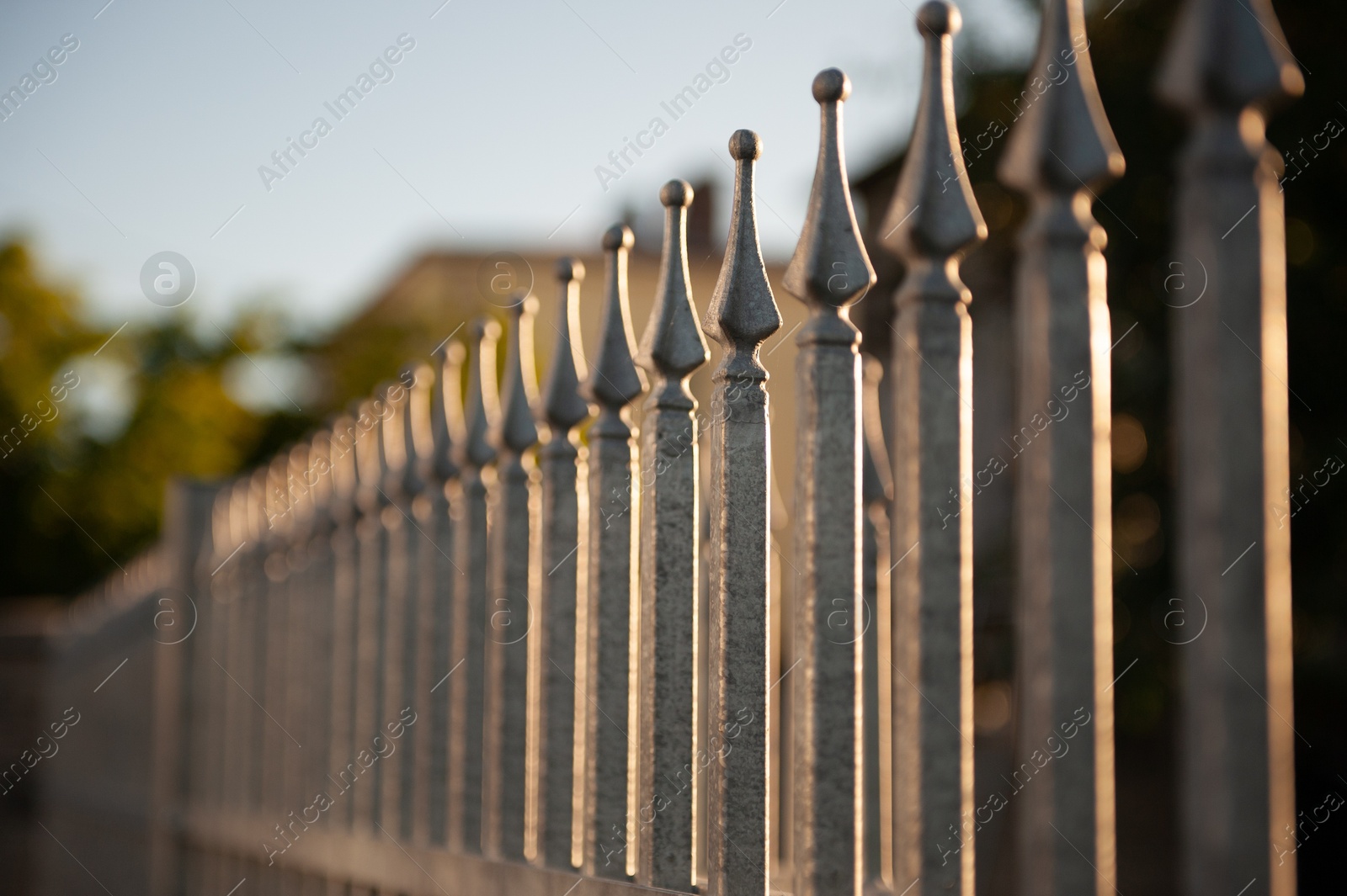 Photo of Beautiful iron fence on sunny day outdoors, closeup