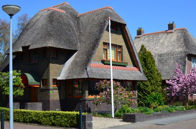 Beautiful residential building with lovely garden on sunny spring day