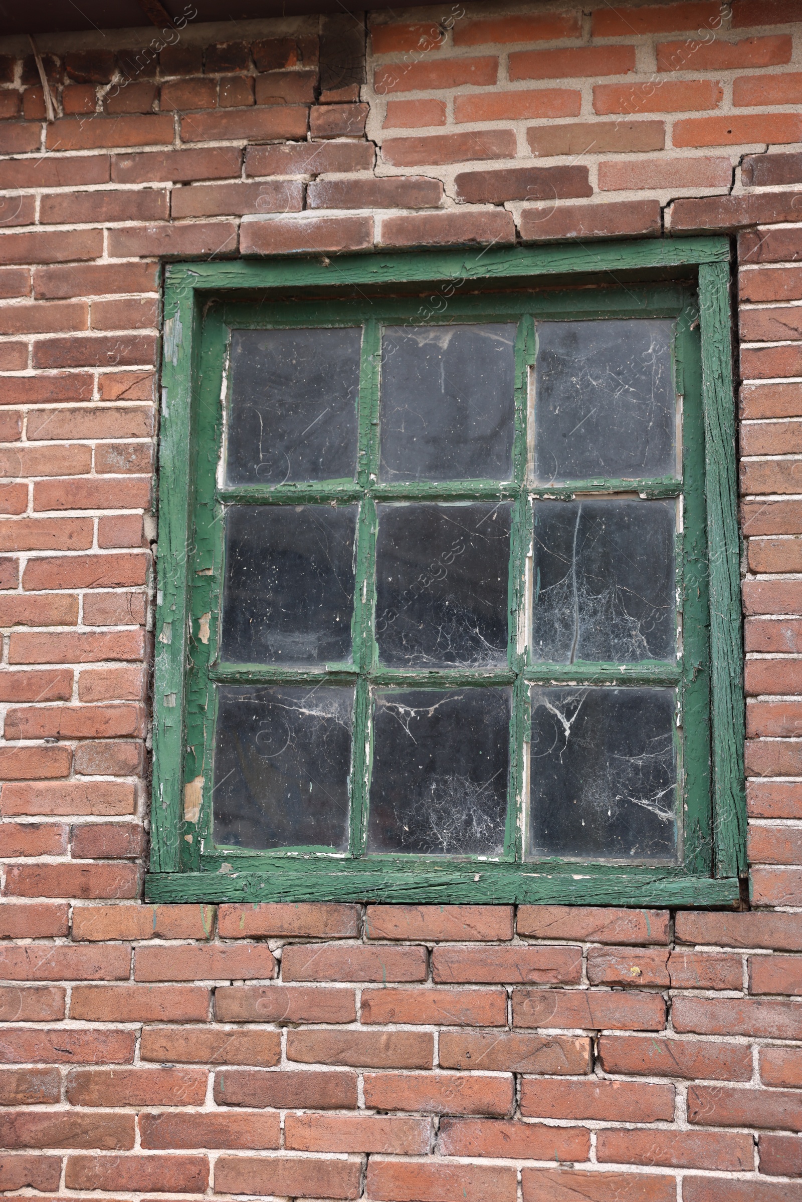 Photo of Old window with green frame in building outdoors